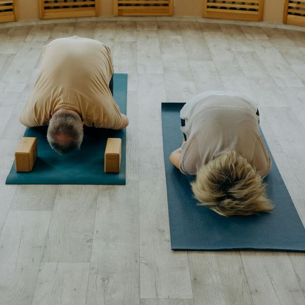 A diverse group of people of different ages practicing yoga together.
