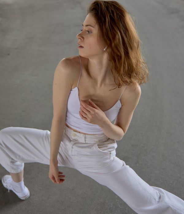 Woman performing a graceful yoga flow in a calm environment.